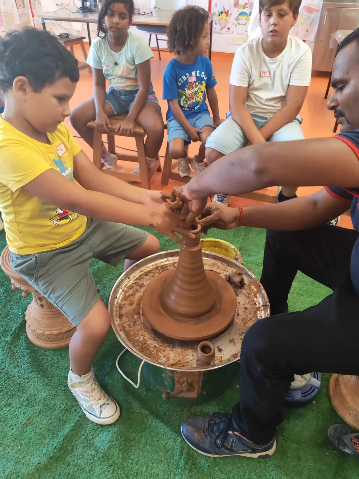 Students exploring handmade pottery with Ram Pottery